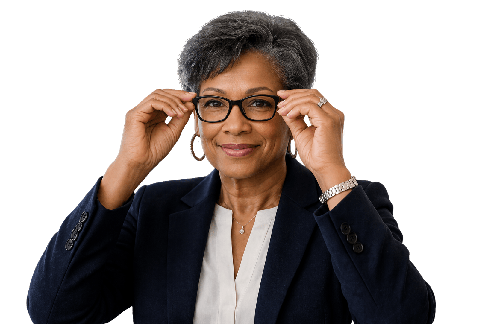 A smiling Black woman with short grey hair, wearing a dark blazer and white shirt, holds black-framed glasses up to her face and looks directly at the camera.